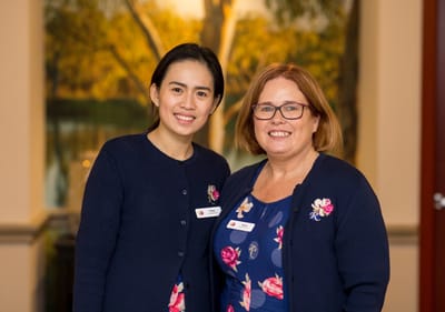 Two smiling staff members in nursing home.