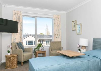 Private resident room with a bed and seating area.