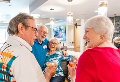 Residents enjoying drinks and conversation in a common area