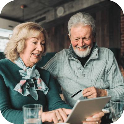 Two seniors enjoying time together with a tablet.