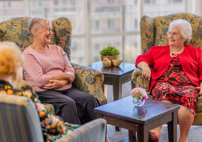 Residents enjoy conversation in a cozy common area.