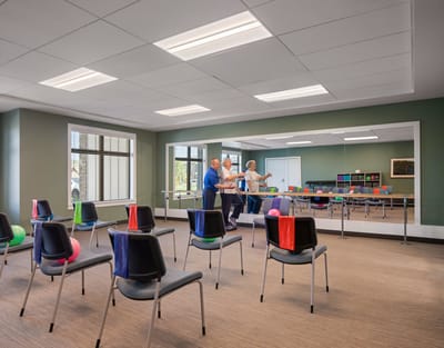 Seniors participating in a group activity in a bright room.