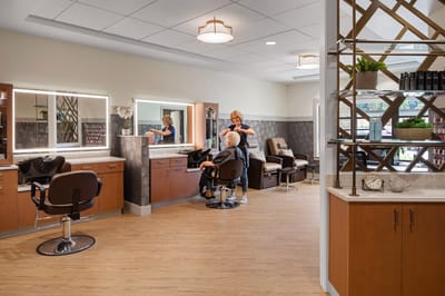 Salon area with a resident receiving a haircut.