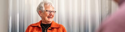 Joyful older woman in bright attire