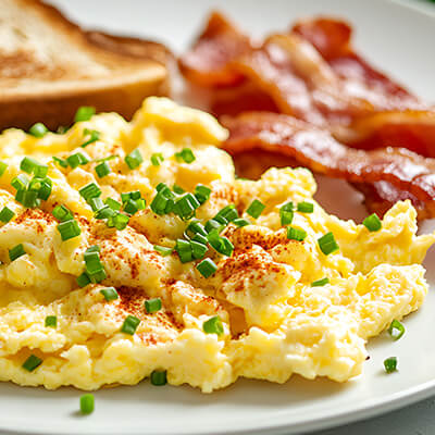 Breakfast plate with scrambled eggs and bacon