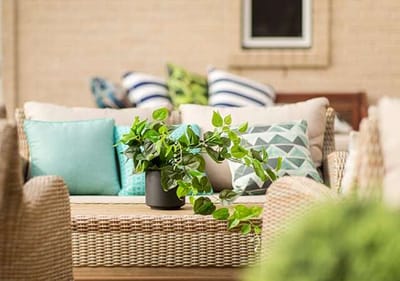 Stylish outdoor seating area with greenery and cushions