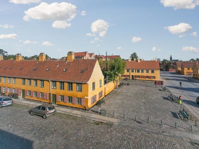 Exterior view of a colorful building in a courtyard.