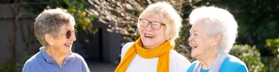 Three smiling seniors enjoying time outdoors