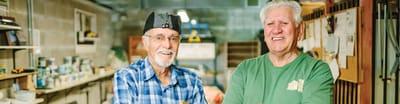 Two smiling residents in a vibrant activity space.