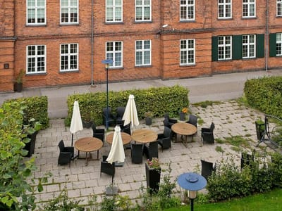 Outdoor seating area with tables and umbrellas