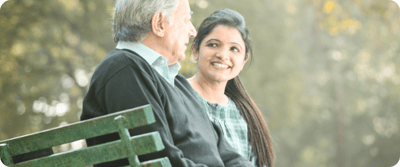 A senior man and woman enjoying a conversation outside.