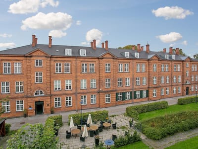 Exterior view of Kastanjehusene facility showing building and garden.
