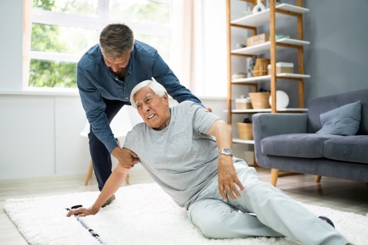 Physical therapy session with an elderly man and caregiver.