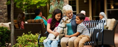 Residents enjoying time with family and a dog