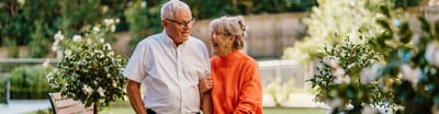Elderly couple laughing together outdoors