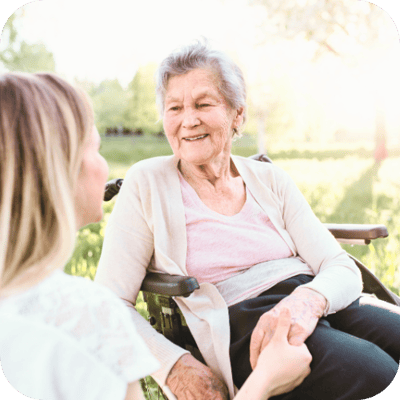 Senior woman enjoying a conversation outdoors.