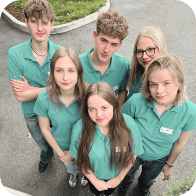 Group of staff members in green shirts.