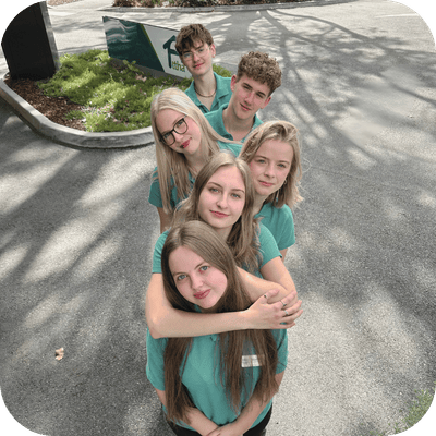 A group of young staff members in green shirts.