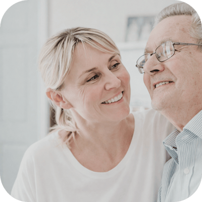 A caregiver smiling with a senior resident.