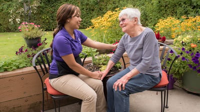 Staff member and resident in a garden