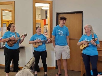 Residents and staff playing ukuleles together