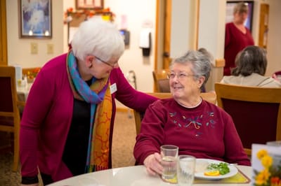 Staff member interacting with a resident during mealtime.