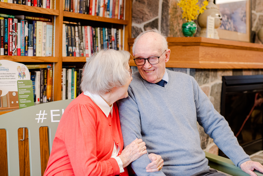 Two residents enjoying a conversation in a cozy common area.