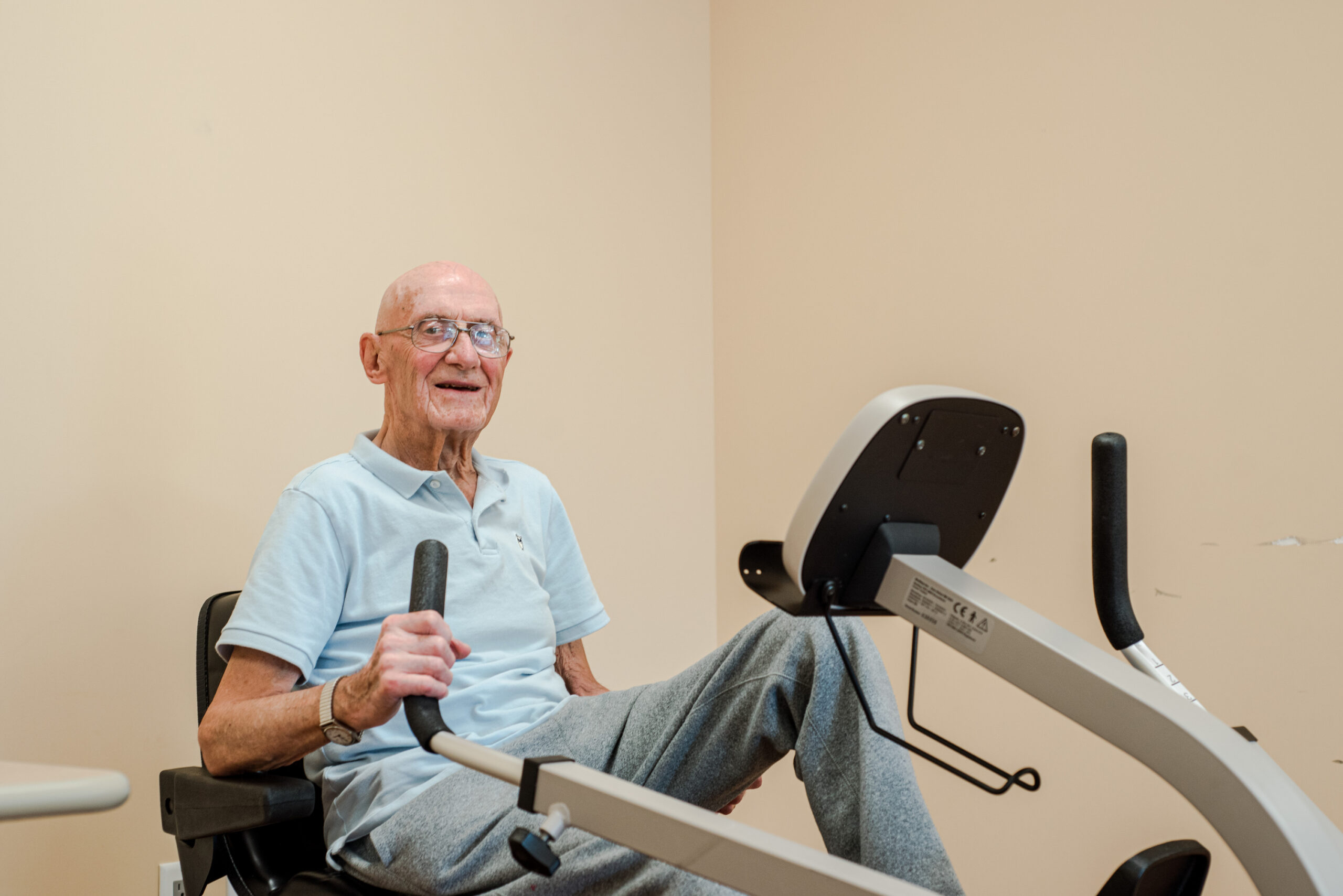 Elderly man exercising on a stationary bike
