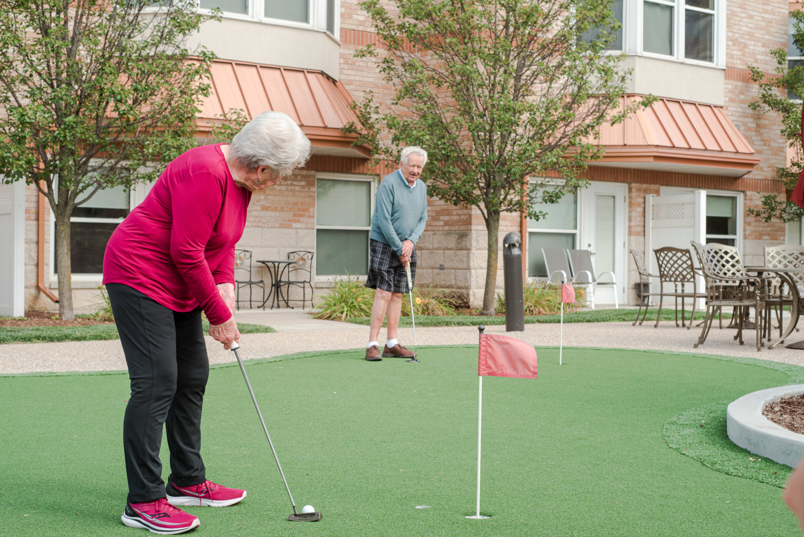 Residents playing mini-golf in the outdoor area