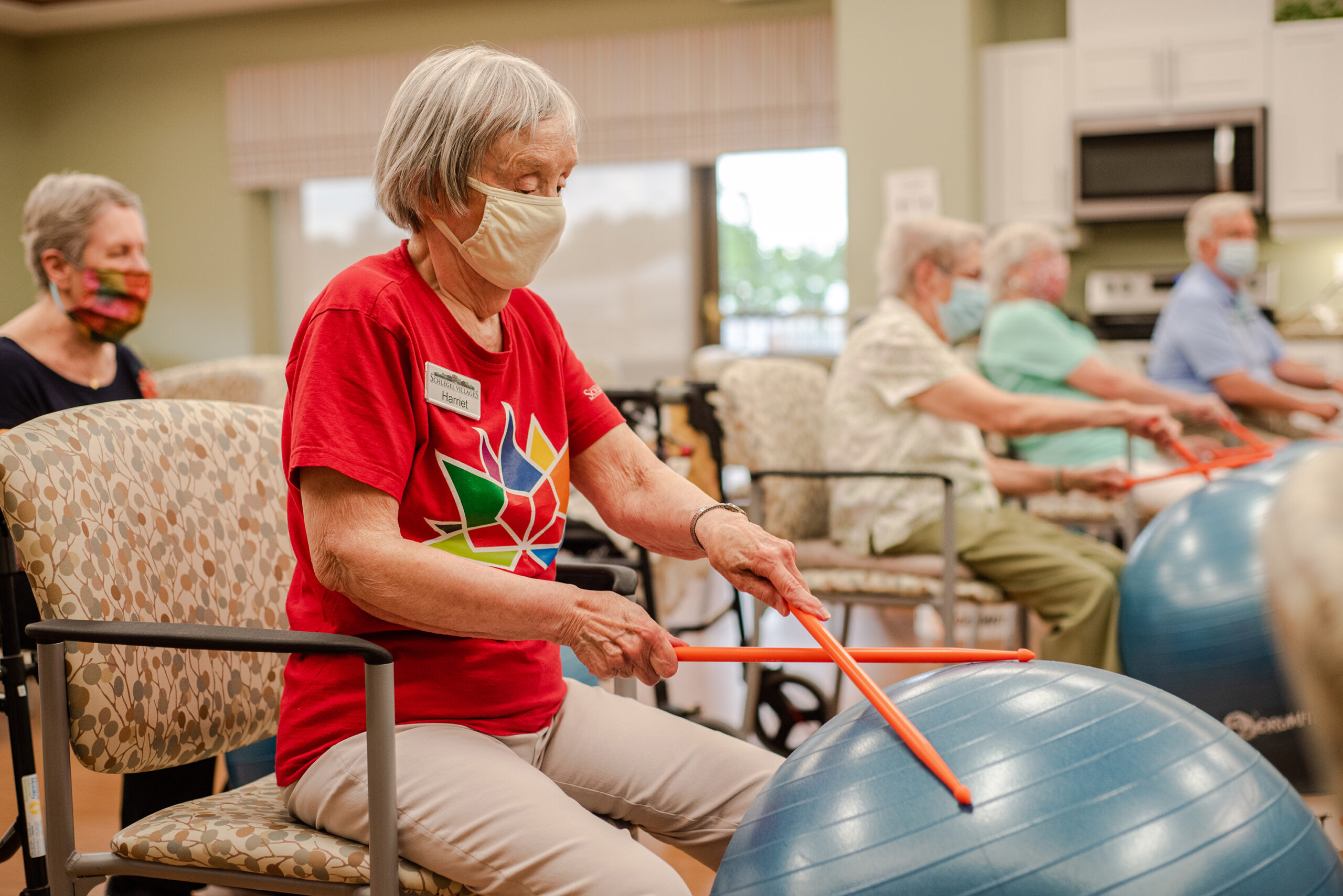 Residents participating in a seated exercise class