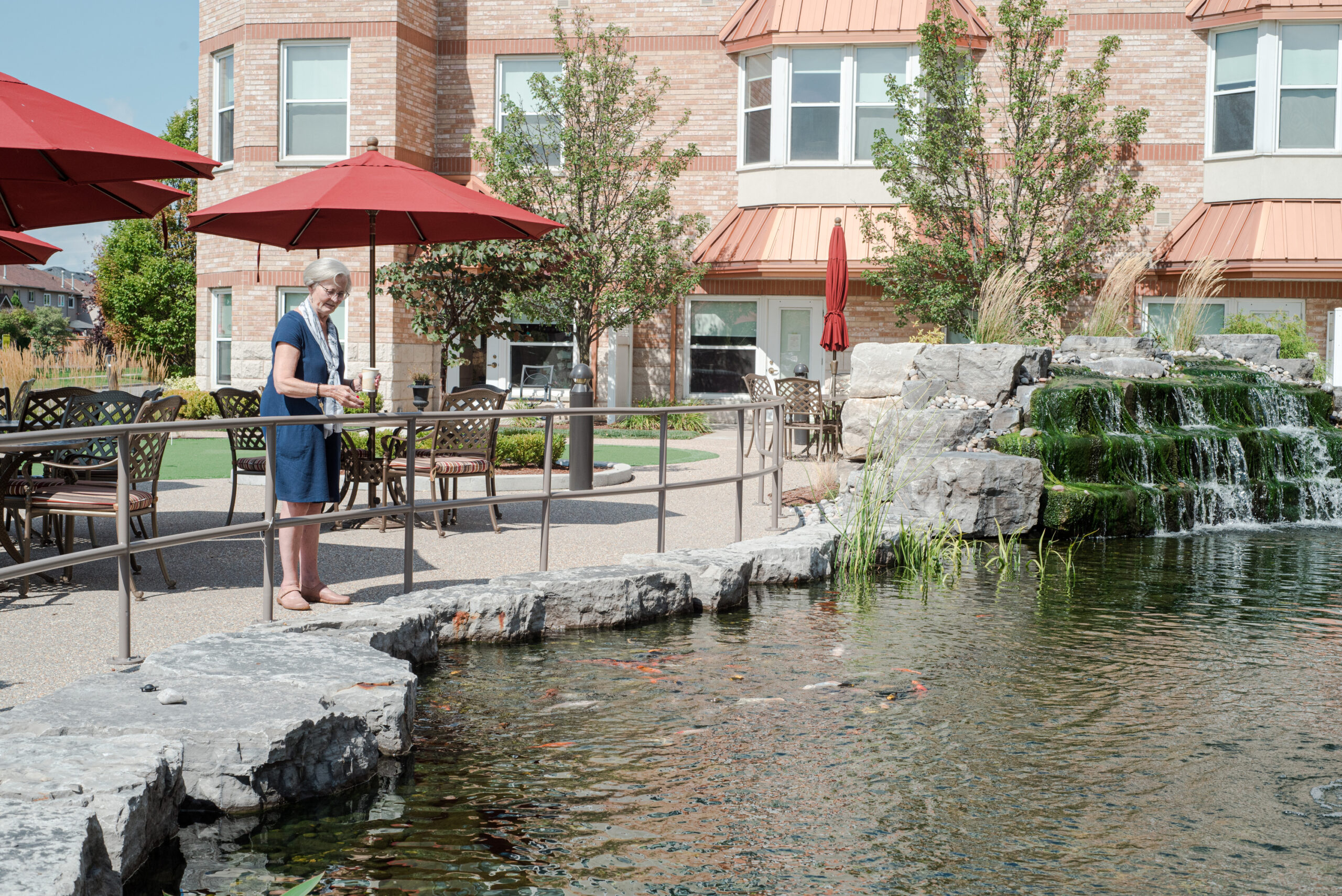 Resident enjoying the outdoor pond and waterfall.