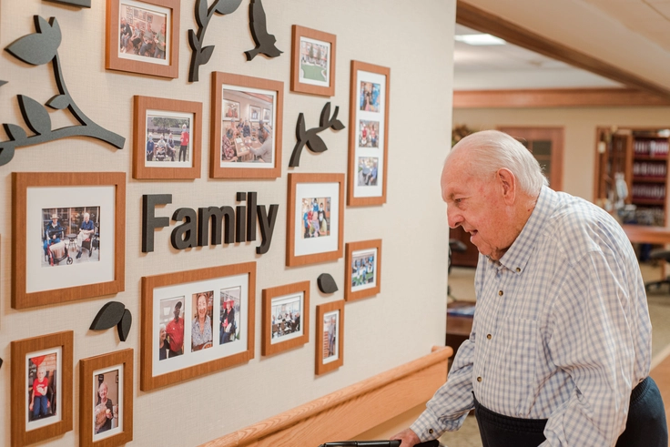 Resident interacting with a family photo display.
