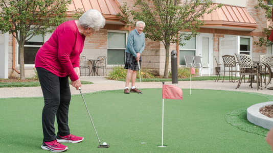 Residents playing mini-golf outdoors