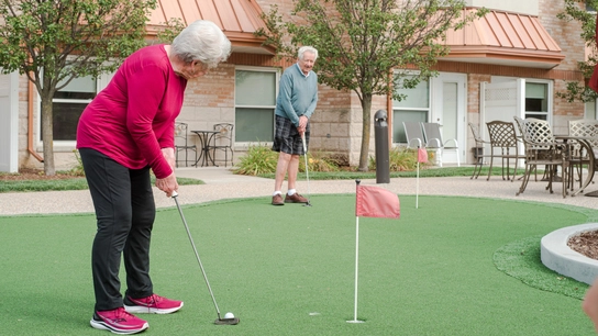 Residents enjoying mini-golf in the garden.