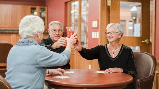 Residents toasting drinks in a common area