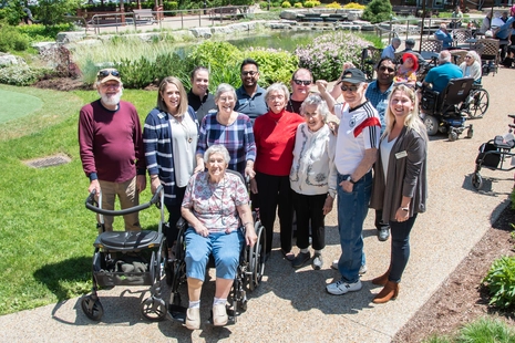 Residents and staff engaging in the outdoor garden area.