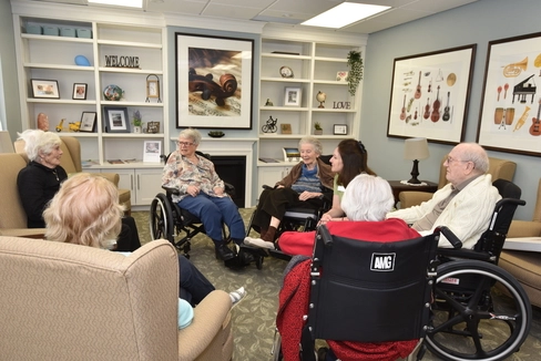 Residents engaged in conversation in a common area.