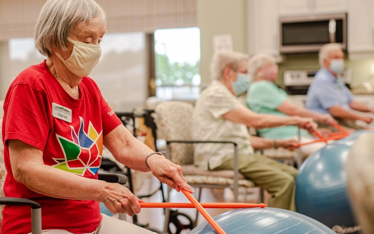 Residents engaging in a fitness activity with exercise balls.