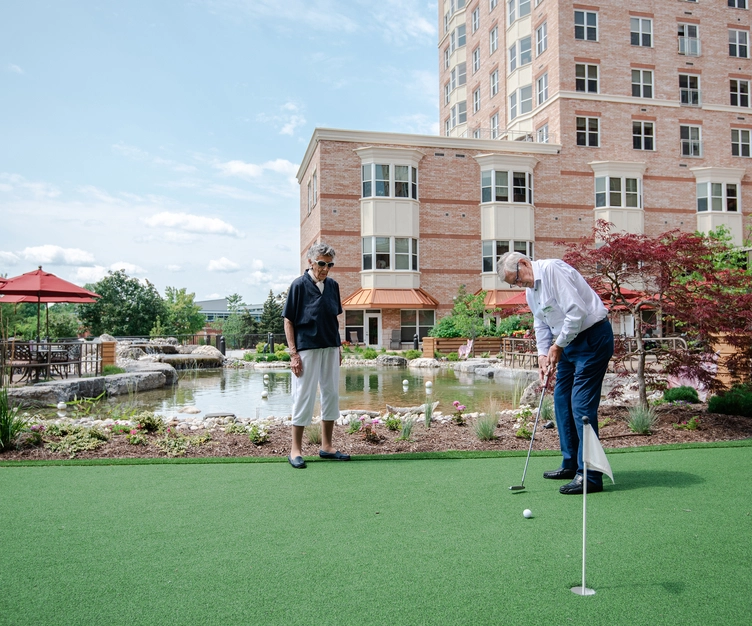 Residents enjoying mini-golf in the courtyard
