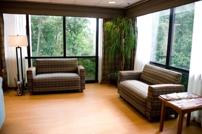 Bright common area with seating and large windows