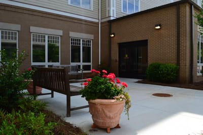 Entrance of a senior living facility with flower pots