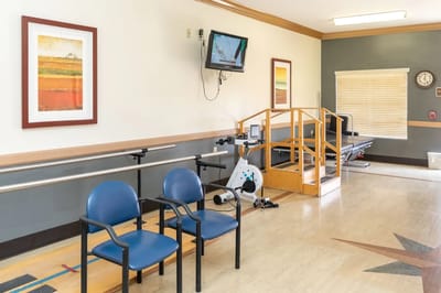 Physical therapy area with equipment and chairs