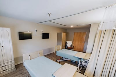 Private resident room with two beds and TV