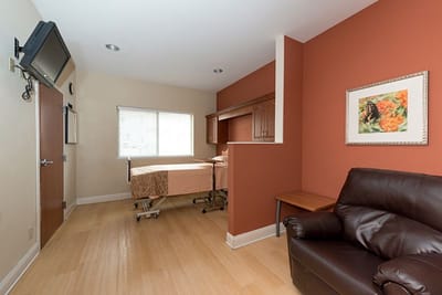 Private room with a bed and seating area