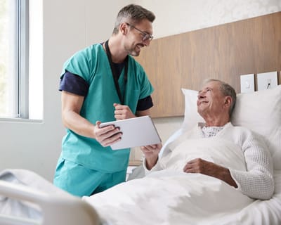 Healthcare worker interacting with a patient in bed