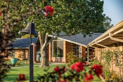 Exterior view of a senior living facility with trees