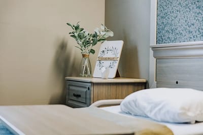 Well-decorated private resident room with bedside table