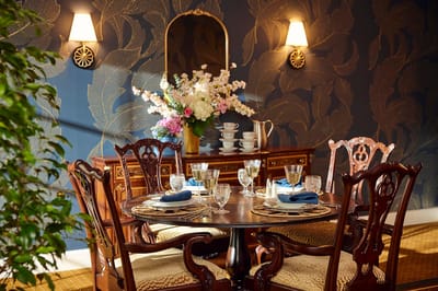 Elegant dining room setup with flowers and table settings