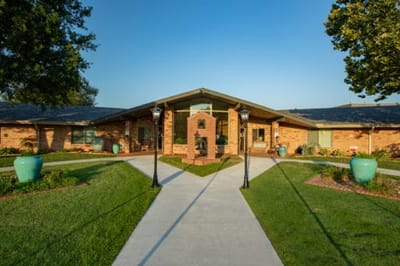 Exterior view of Bellevue Health & Rehab Center with gardens