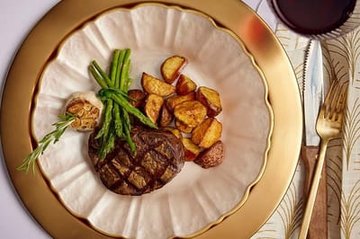Gourmet steak dinner with vegetables and potatoes